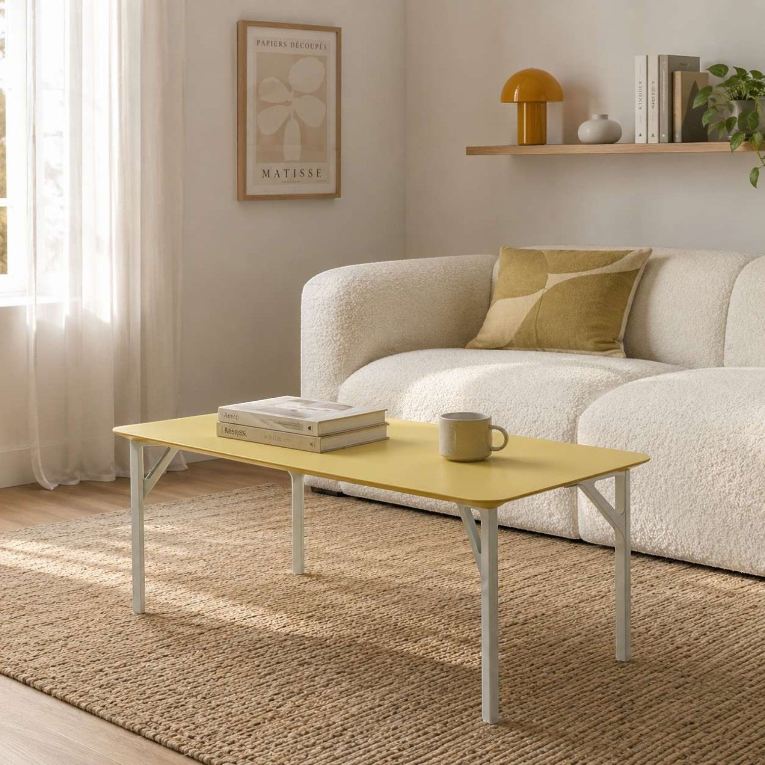 Addo Shop Fly rectangular coffee table with a yellow wood veneer top and white metal legs in a minimalist living room.