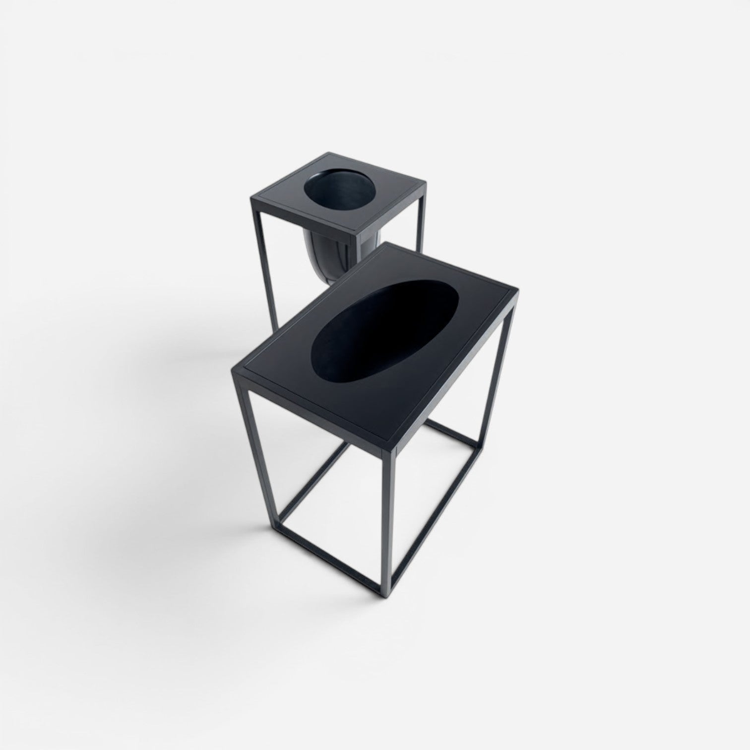 Addo Shop Florianopolis Planter 59, a modern black metal planter with an open rectangular frame and a recessed oval basin.