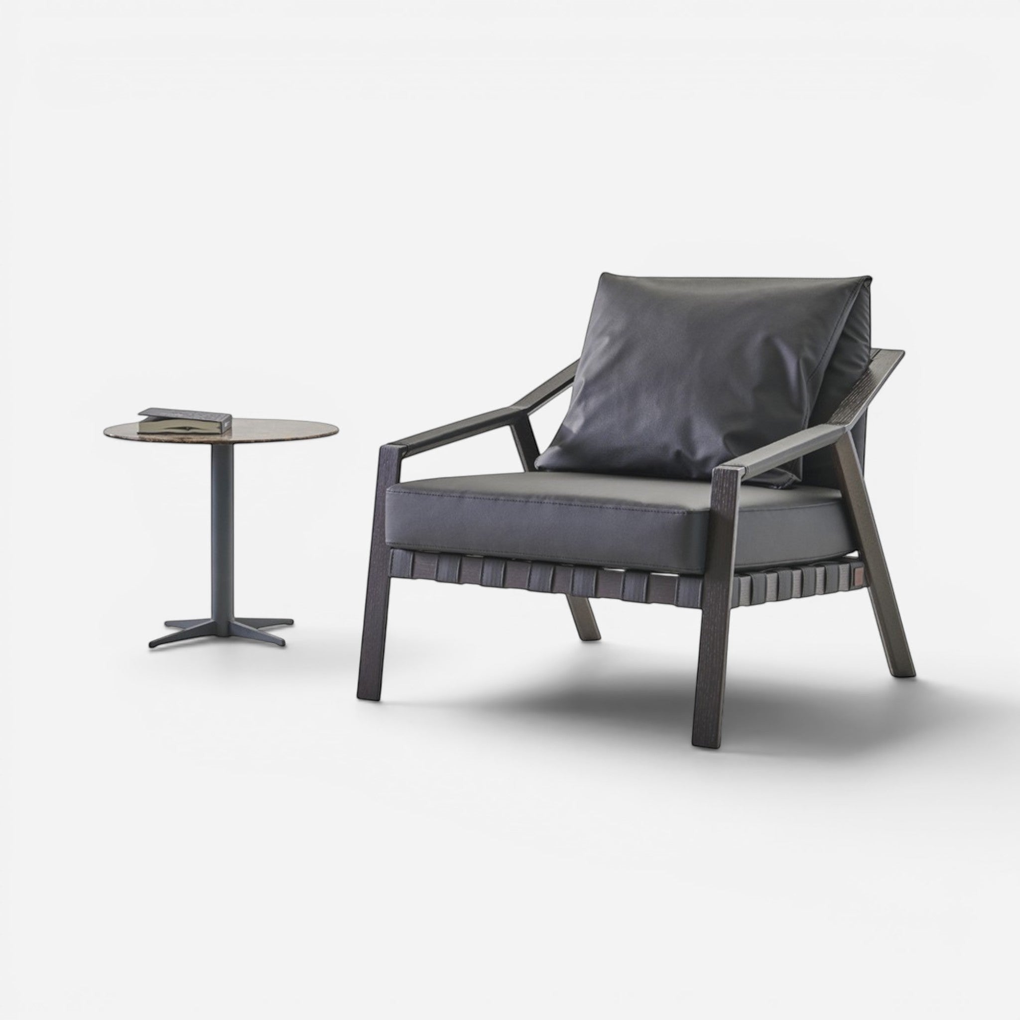 Addo Shop Lares lounge chair with dark oak frame and dark grey faux leather upholstery. Modern armchair with cushion.