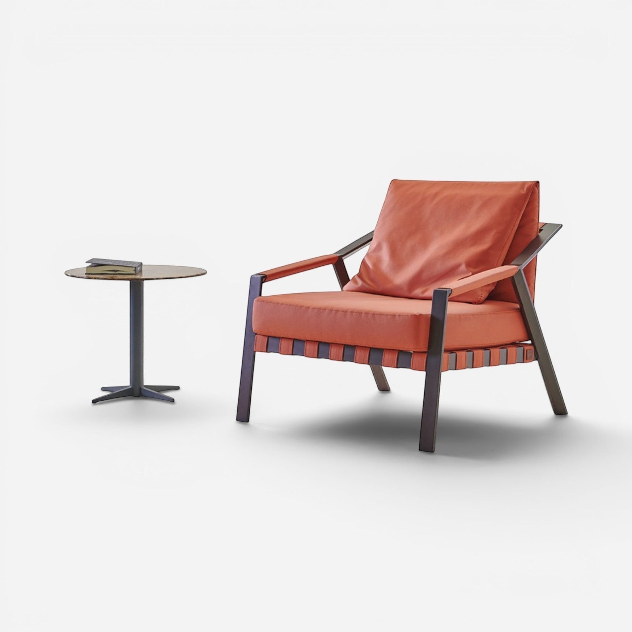 Addo Shop Lares lounge chair with orange cushions and oak wood frame, featuring a woven seat detail.