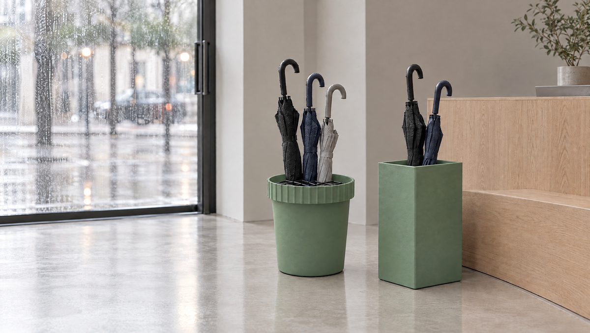 Yağmurlu bir günde ofis girişinde yeşil Raffles System ve Design Collection şemsiyelikler