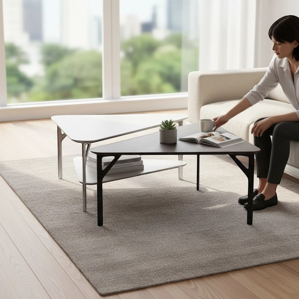 Addo Shop Fly Coffee Table, triangular dark wood top with black legs and shelf, next to white table.