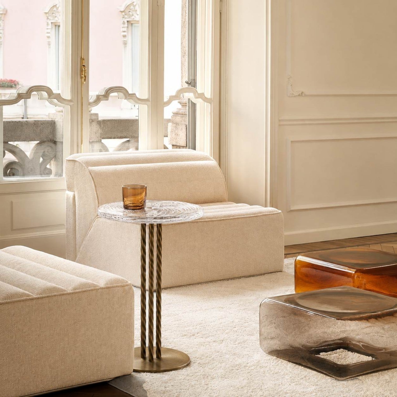 Addo Shop modern beige textured lounge chair with a glass side table in a bright living room setting
