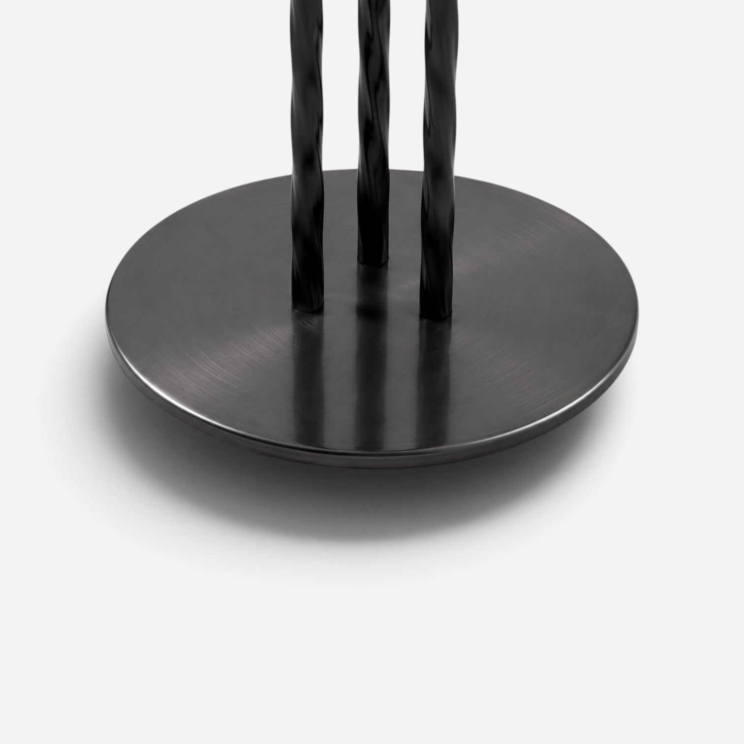 Addo Shop black metal table base with a circular brushed finish plate and three twisted vertical support rods