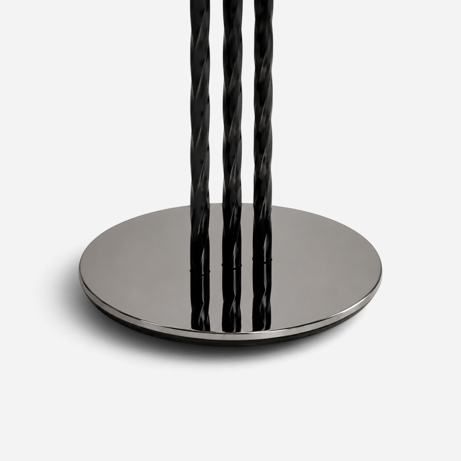 Addo Shop black twisted metal table base with a polished chrome circular floor plate