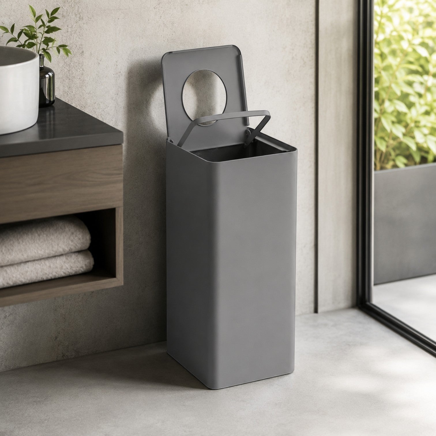 Addo Shop Centolitri 100L grey recycling bin with a modern slim design and circular lid opening in a bathroom setting.
