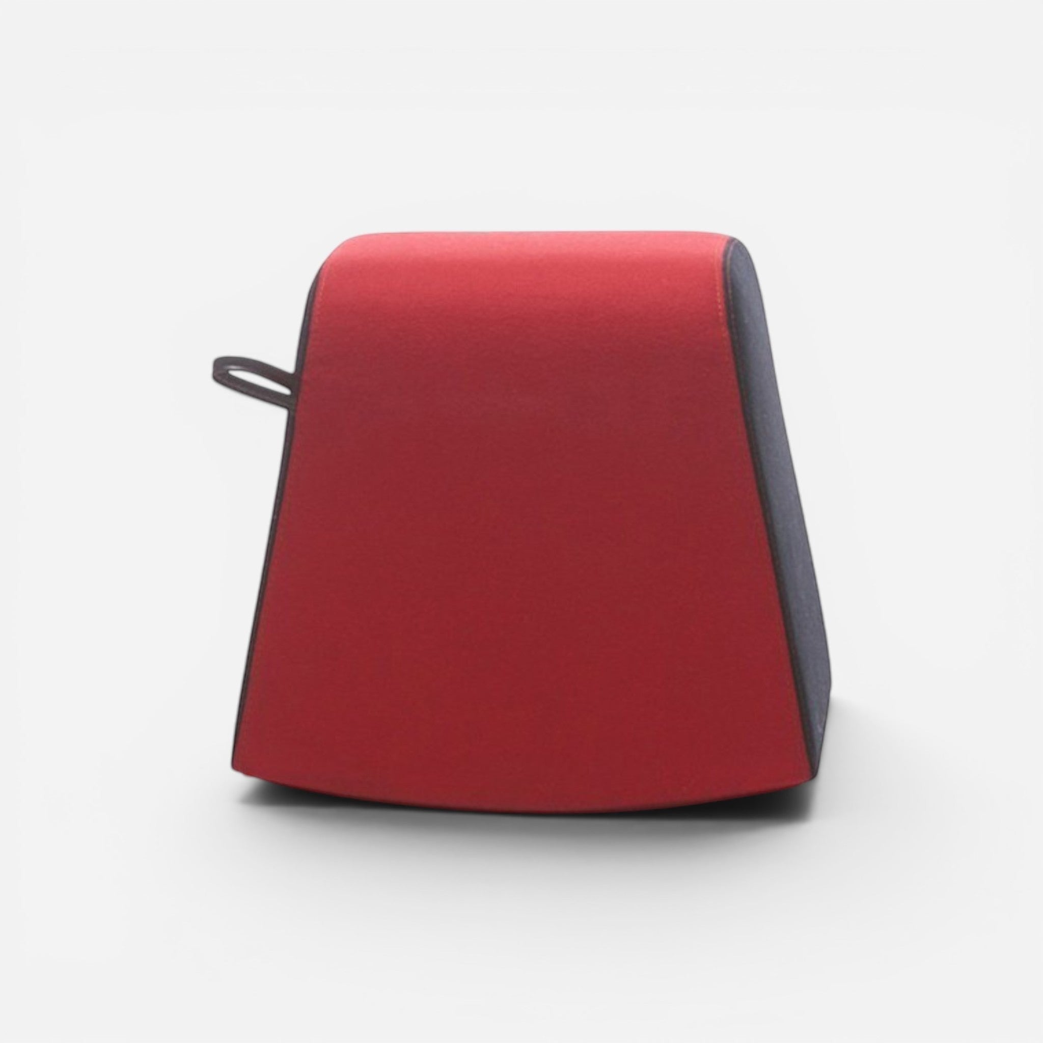 Addo Shop Dondolo Puf ottoman in red faux leather with a dark grey base and a small loop handle.