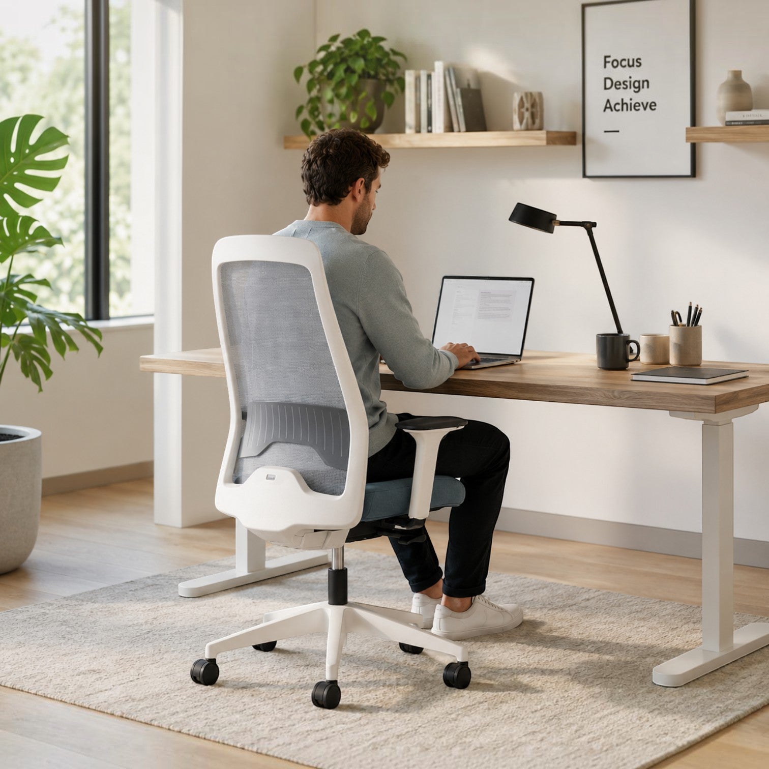 Addo Shop Every ergonomic office chair with white frame and grey mesh backrest, used by a man at a wooden desk.