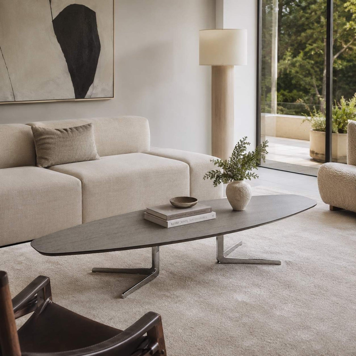 Addo Shop Flamingo low oval center table with dark wood veneer top and chrome twin-base in a modern living room.