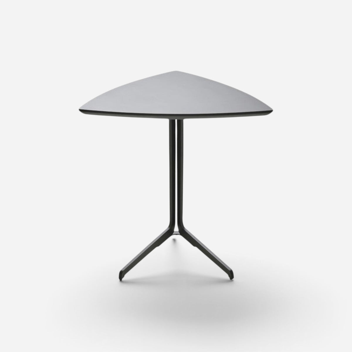 Addo Shop Flamingo low triangular side table with a matte black lacquer top and powder-coated metal tripod base.