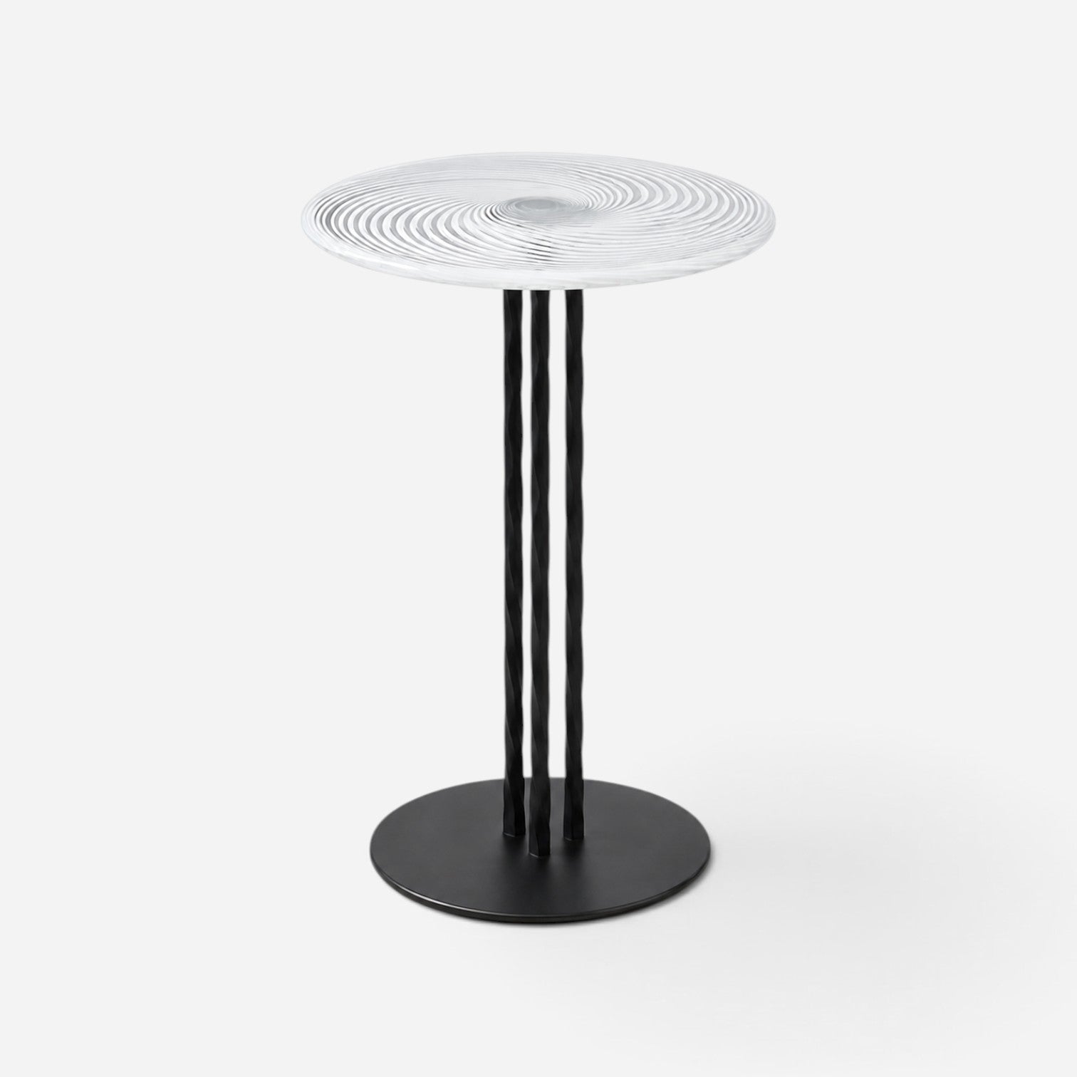 Addo Shop round side table with a clear glass swirl pattern top and three black twisted metal legs on a round base.