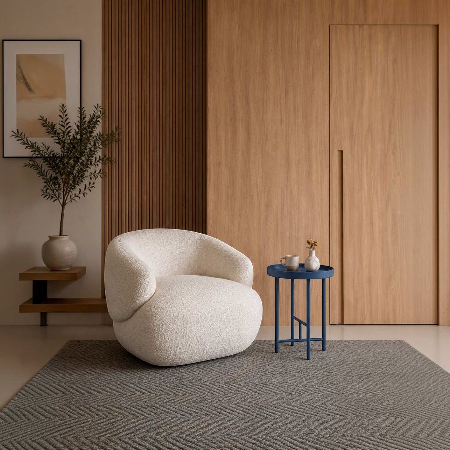 Addo Shop Indra side table in blue lacquer with a minimalist metal frame next to a white boucle armchair