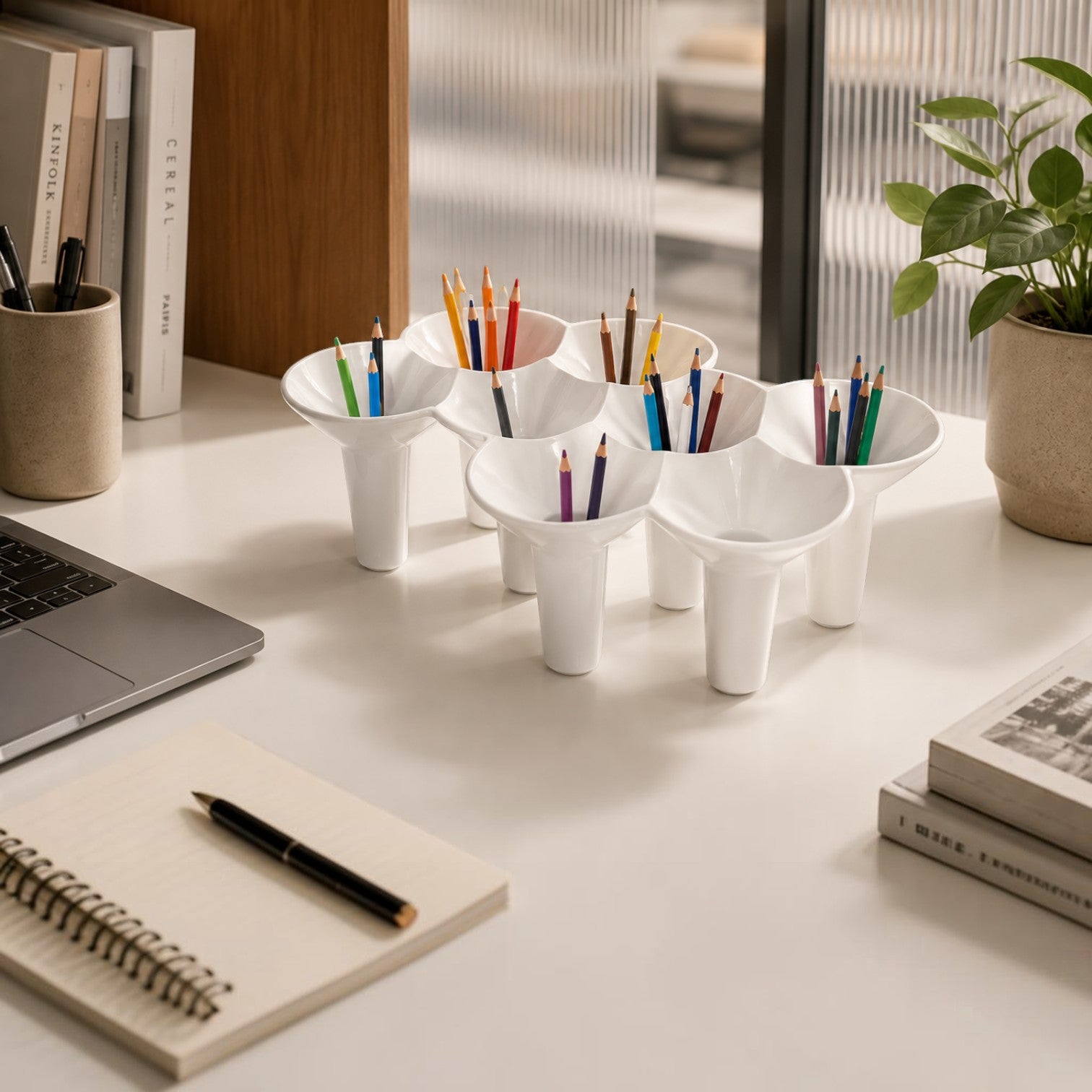 Addo Shop KABO white ceramic umbrella stand and organizer holding colored pencils on a desk.