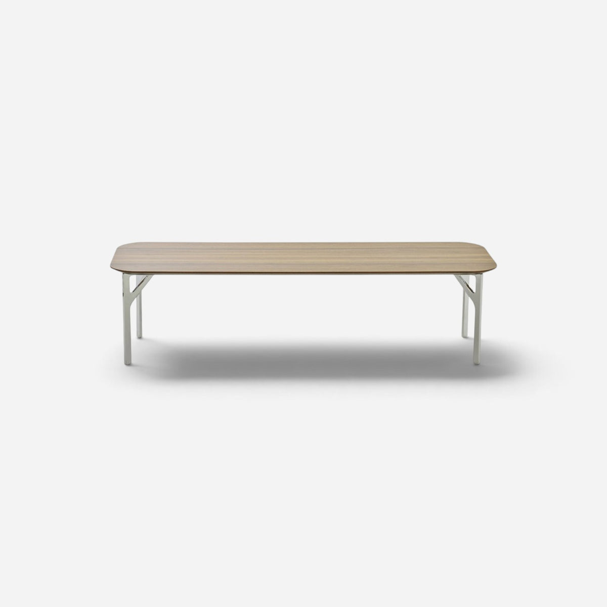 Addo Shop Fly long rectangular coffee table with a wood veneer top and slim metal legs on a white background