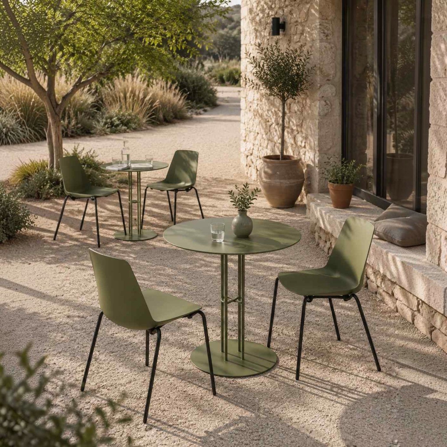 Addo Shop Marvin cafeteria chairs with olive green polypropylene shells and black metal legs on a stone patio.