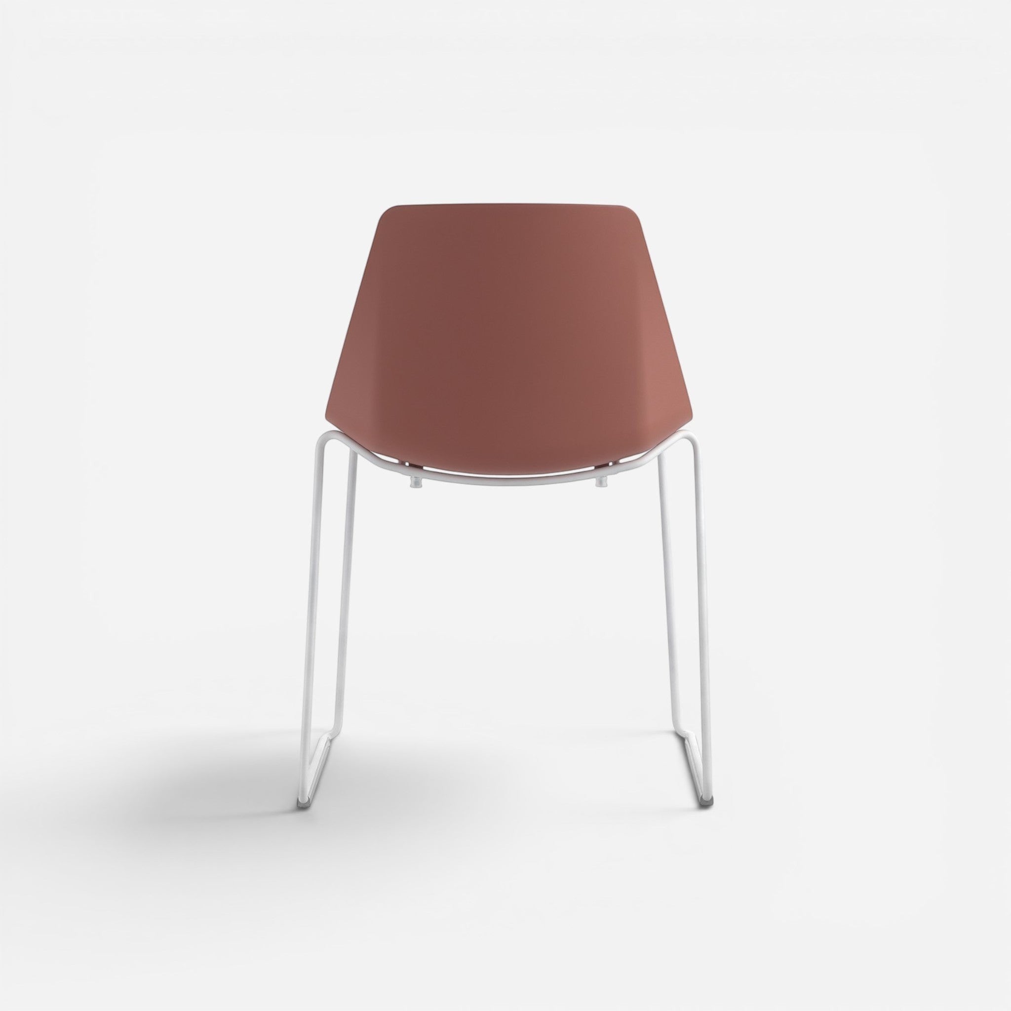 Addo Shop Marvin cafe chair with a terracotta plastic seat and back, and white metal sled legs.