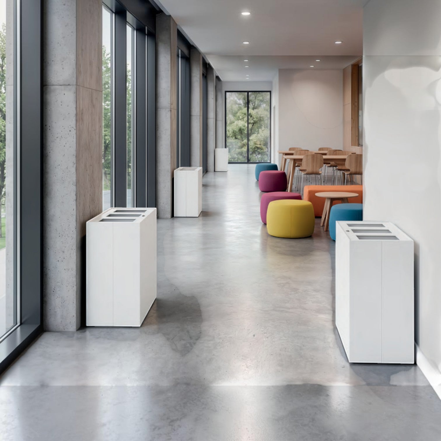 Addo Shop Maximo Lock 150L white recycling bin in a modern office hallway with concrete floors and colorful seating.