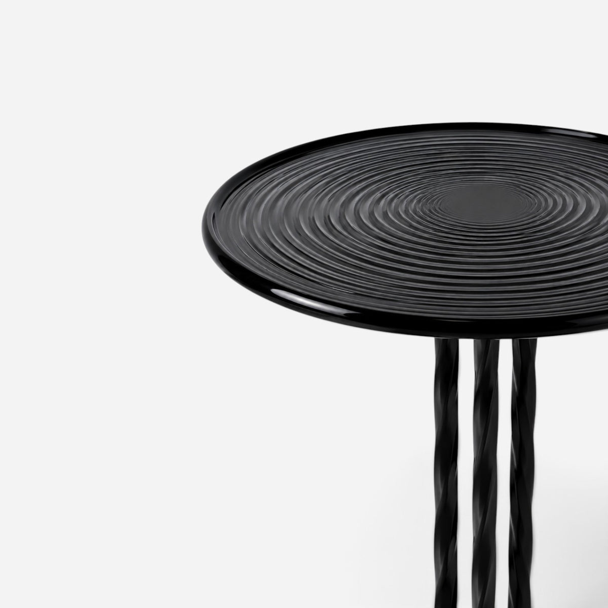 Addo Shop NAVIN duo side table with a glossy black circular top featuring a ripple pattern and twisted metal legs.