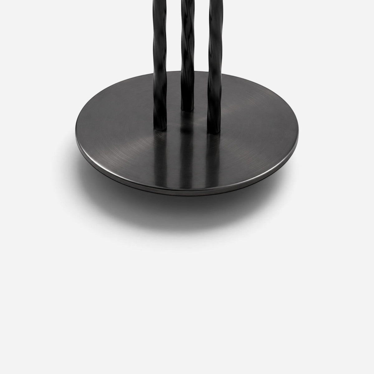 Addo Shop NAVIN duo coffee table set featuring a round black metal base with three twisted vertical support legs.