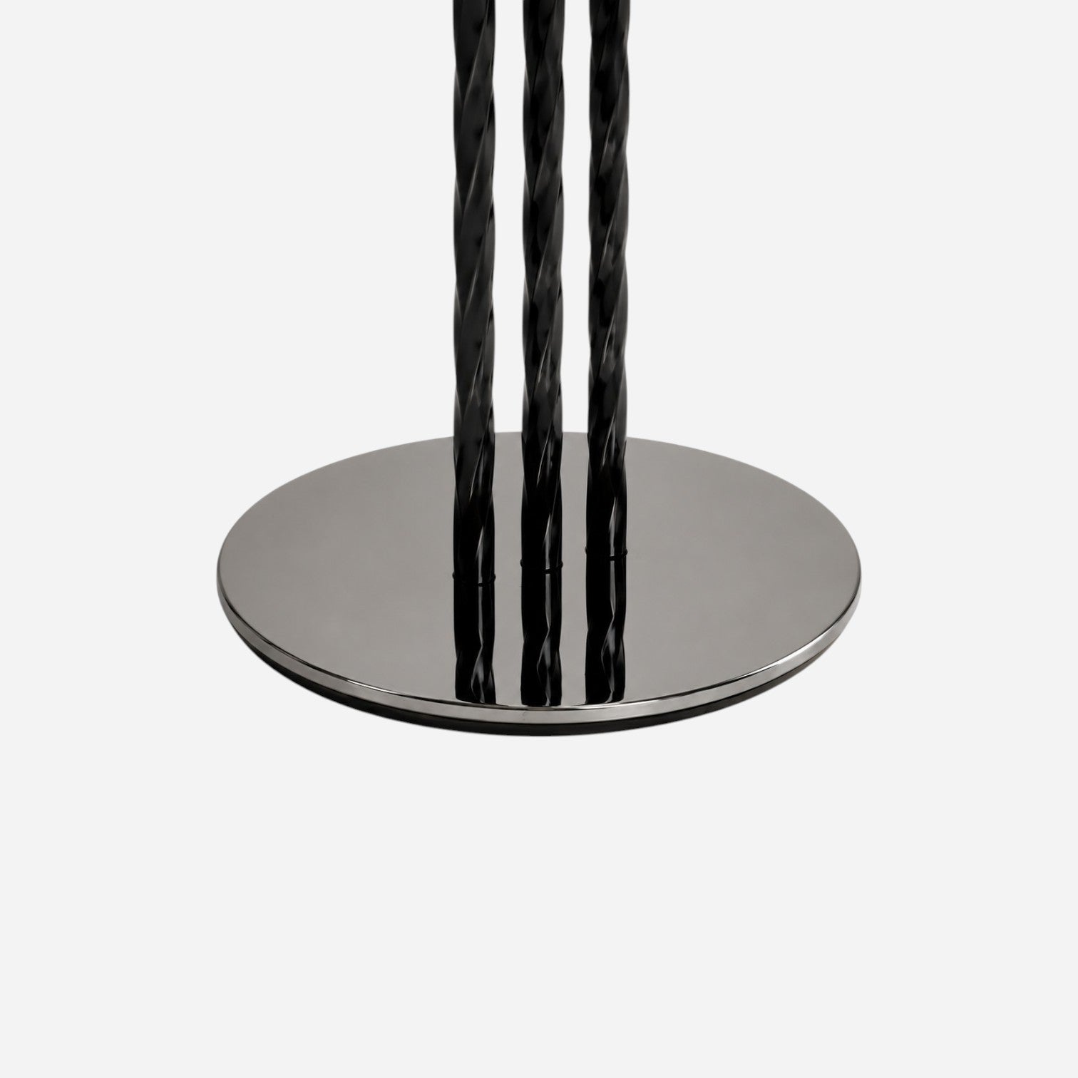Addo Shop NAVIN Duo coffee table set featuring a polished chrome circular base with three twisted black metal legs.