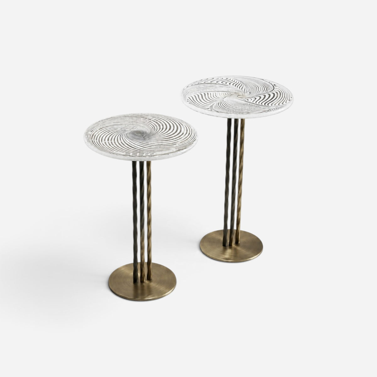 Addo Shop NAVIN duo side table set featuring circular glass tops with spiral patterns and metallic bronze bases.