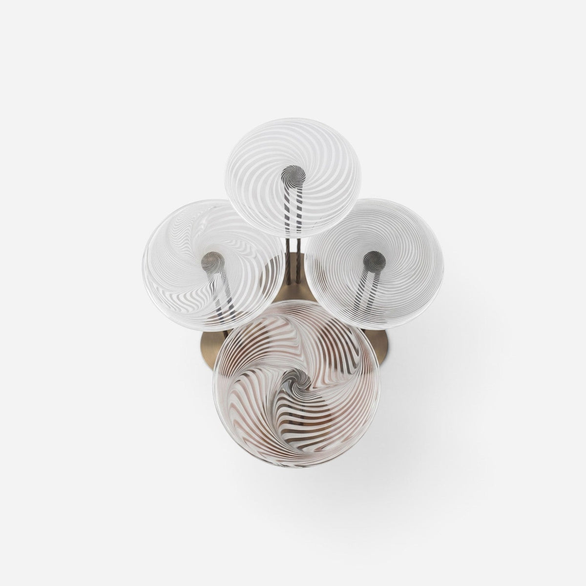 Addo Shop NAVIN Quartet nest of tables featuring four circular glass tops with a swirling white and clear pattern