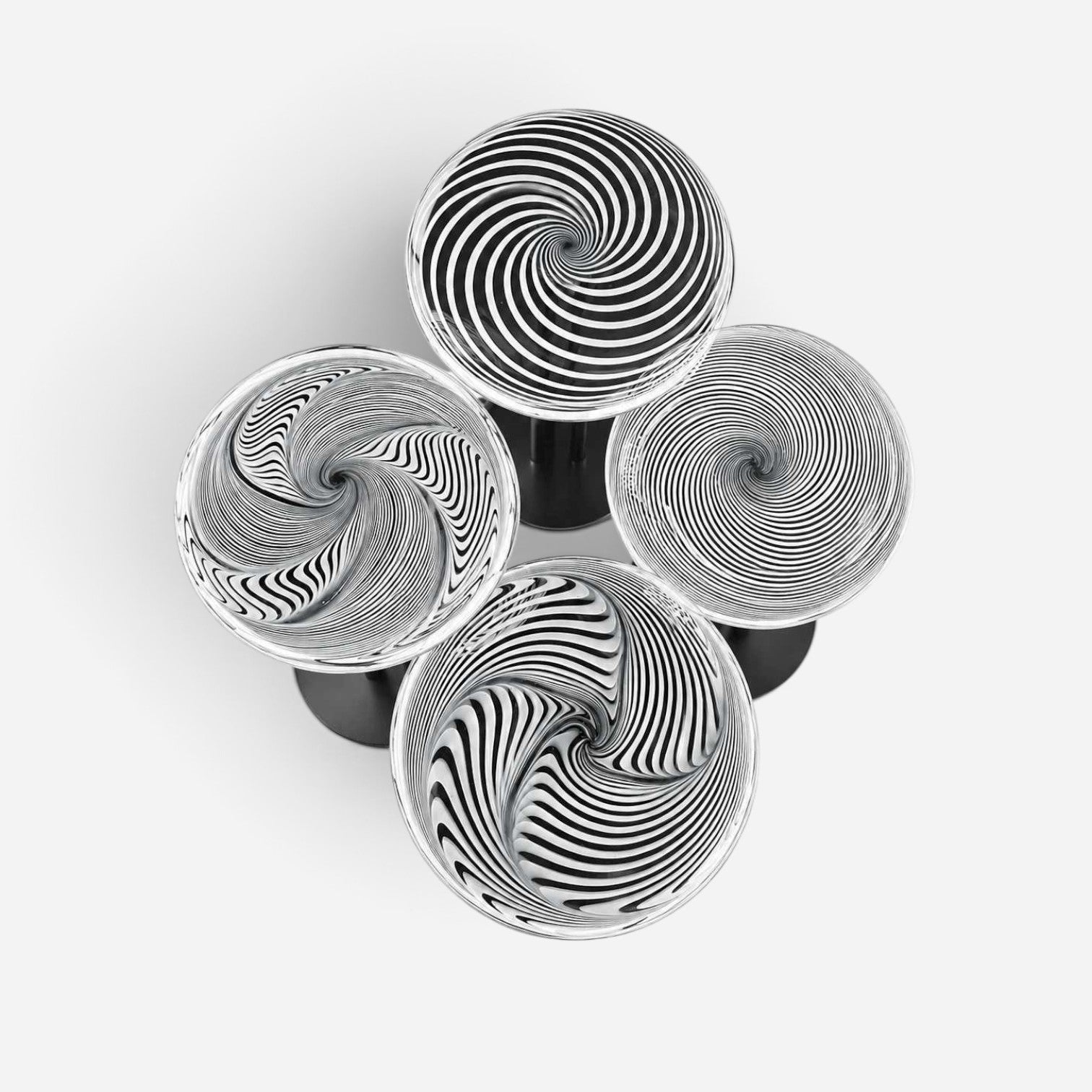 Addo Shop NAVIN Quartet coffee table set with black and white spiral patterned glass tops, top-down view