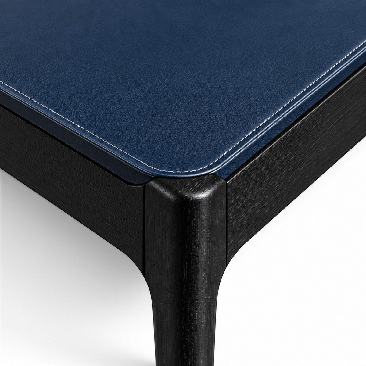 Addo Shop ODAK DÜĞÜM chair featuring a dark blue leather seat with white contrast stitching and black wooden legs.