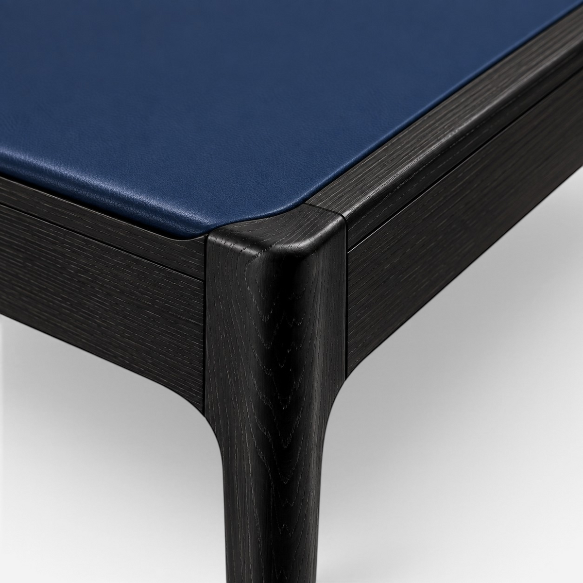 Addo Shop ODAK RAY chair featuring a dark stained wooden frame and a smooth navy blue leather seat cushion