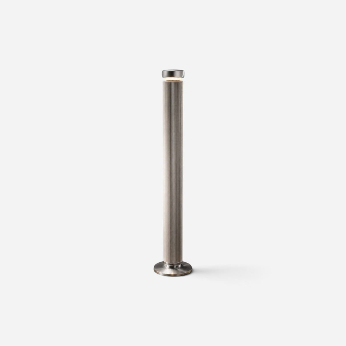 Addo Shop PILON floor lamp in brushed aluminum with a vertical ribbed cylindrical design and minimalist aesthetic.