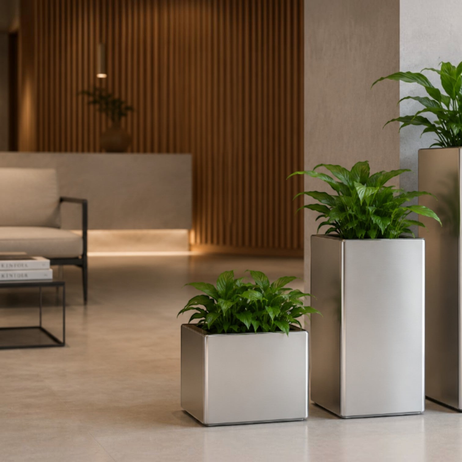 Caimi PRISMA indoor planters in metallic silver finish, styled in a modern office lounge from Addo Shop.