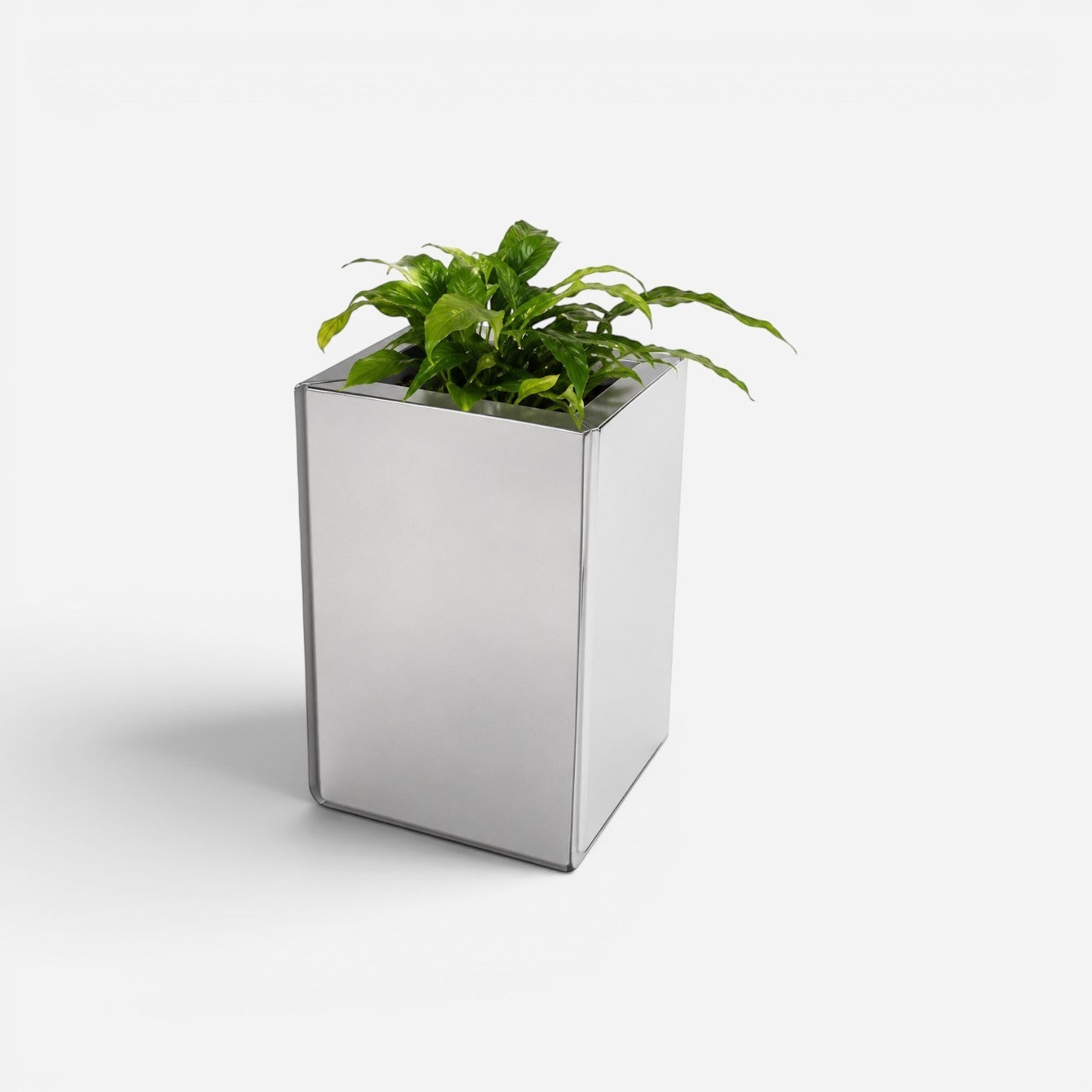 Addo Shop PRISMA outdoor planter in a sleek, reflective silver metal finish with a lush green plant inside.