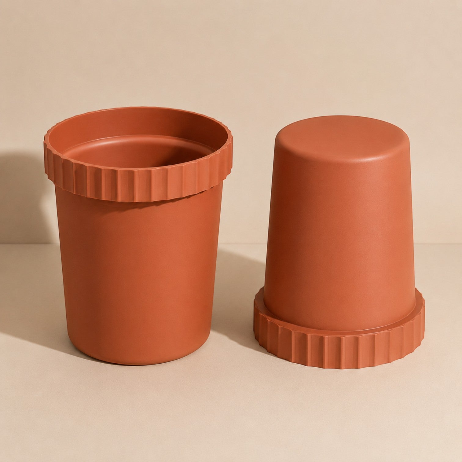 Addo Shop RAFFLES SYSTEM terracotta-colored planter with a modern ribbed rim design on a neutral background.