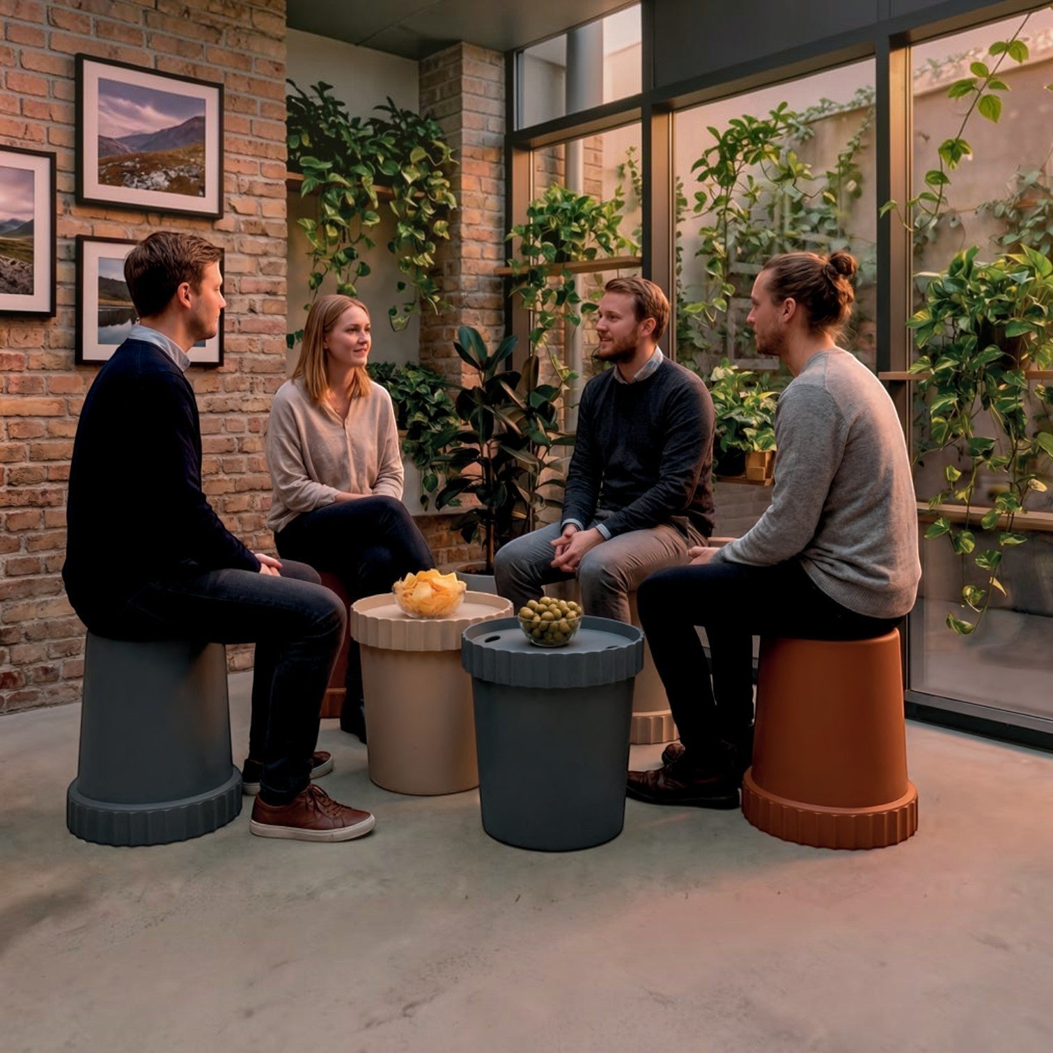 Addo Shop Raffles System Stools in various colors used as seating and side tables in a modern indoor garden setting.