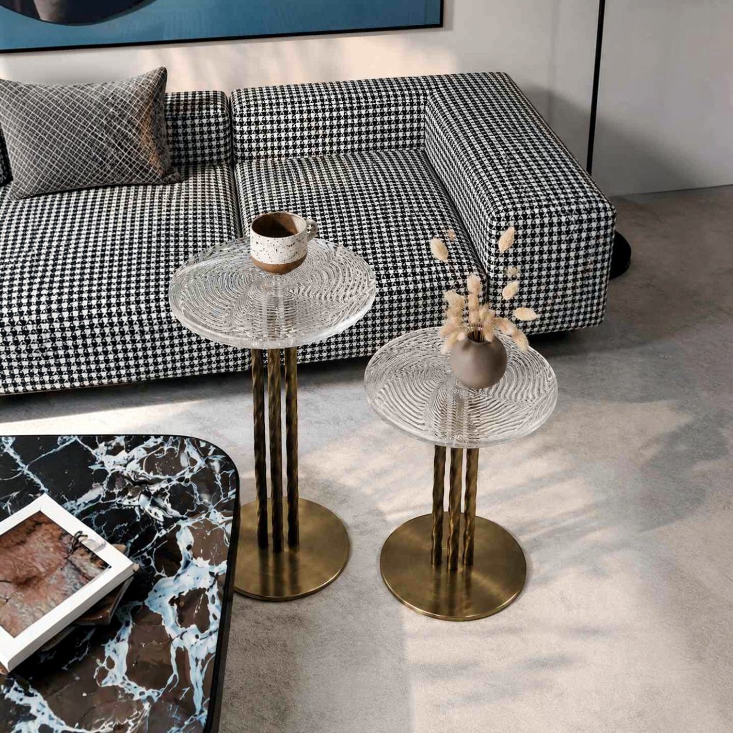Addo Shop set of two round side tables with textured glass tops and fluted brass metal bases in a modern living room