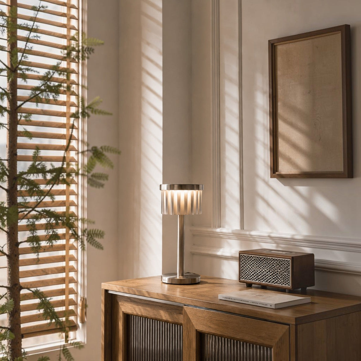 Addo Shop Şems-1 modern metal table lamp with glass rod shade on a wooden sideboard in a sunlit room