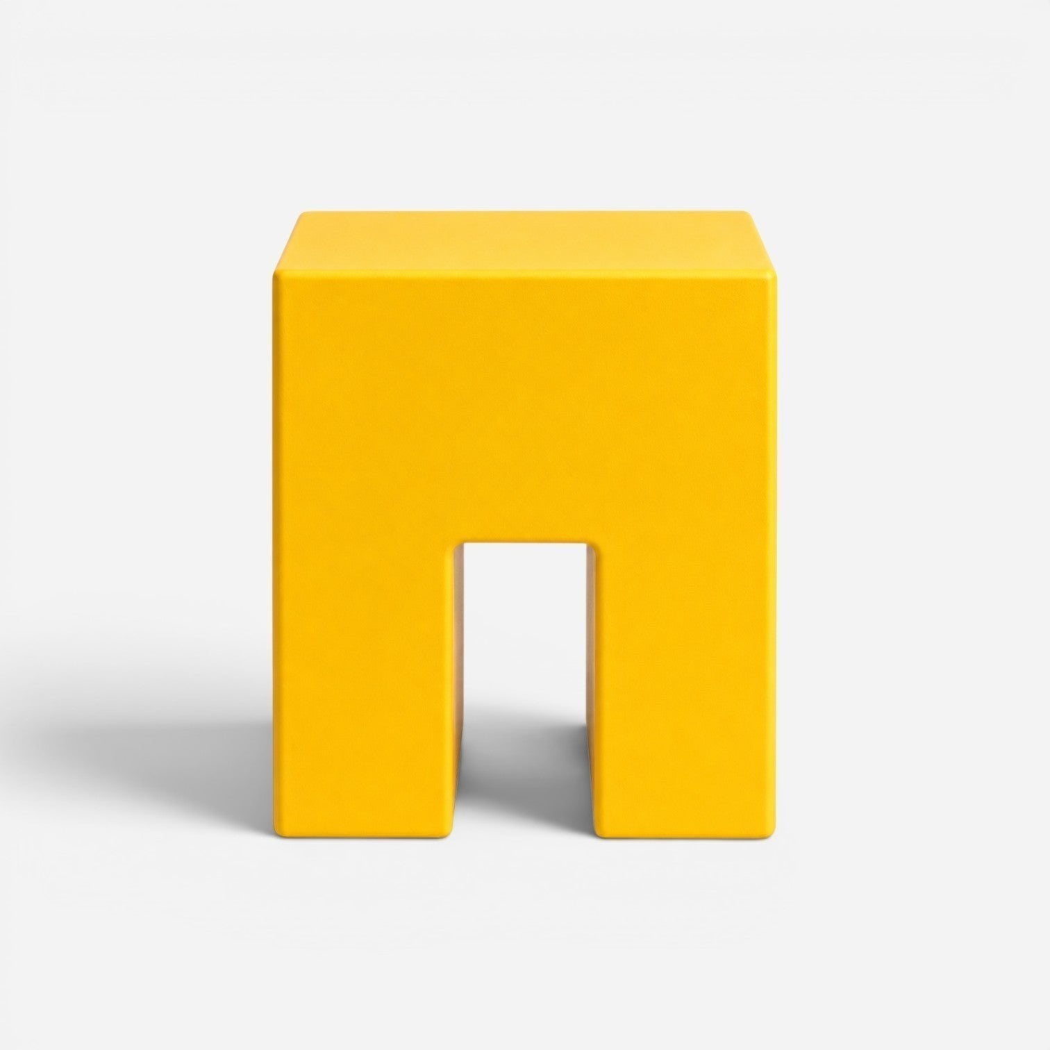 Addo Shop STILEMI Cube modern yellow minimalist stool with a geometric U-shaped design on a white background.