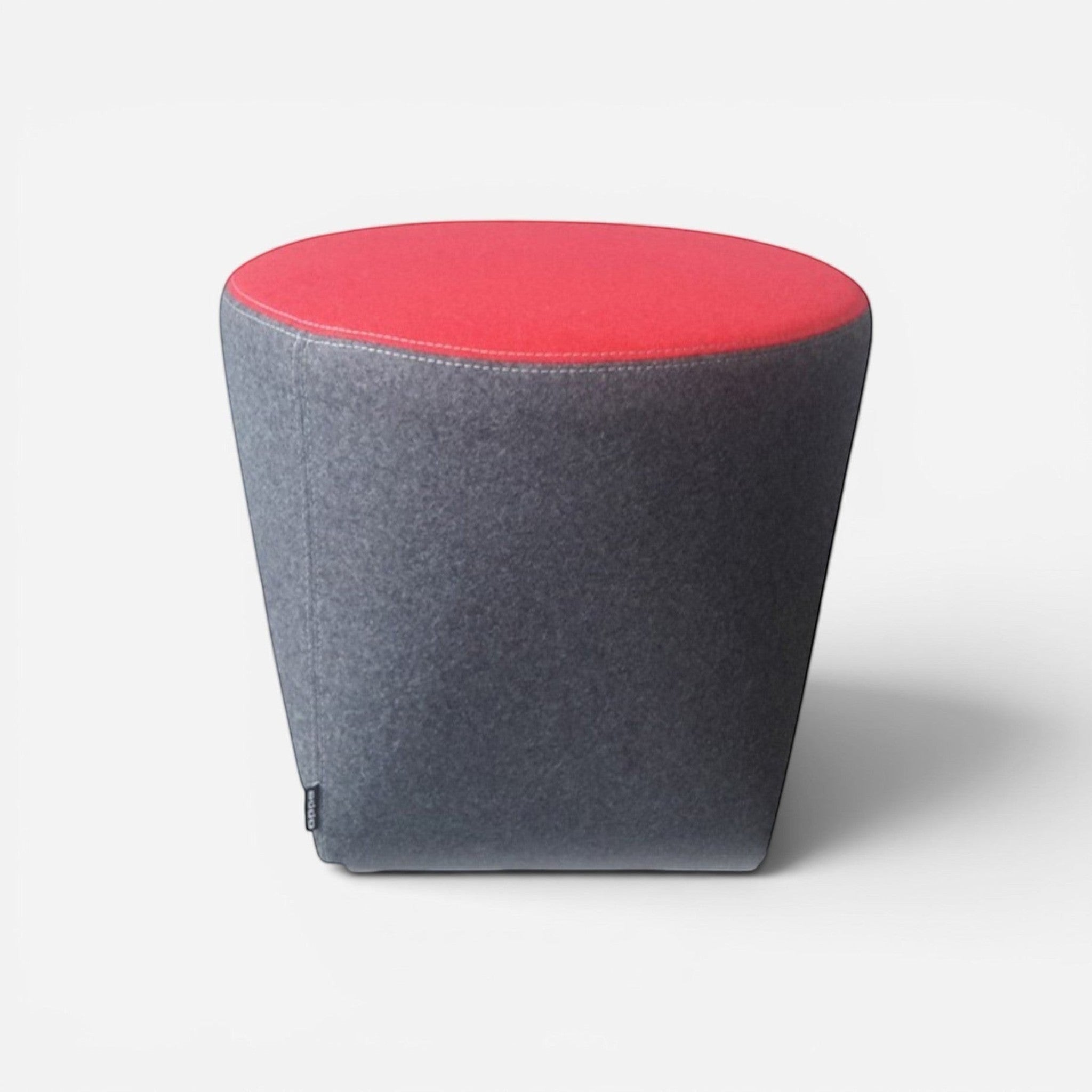 Addo Shop Swap pouf with grey felt base and red faux leather top. Modern conical design.