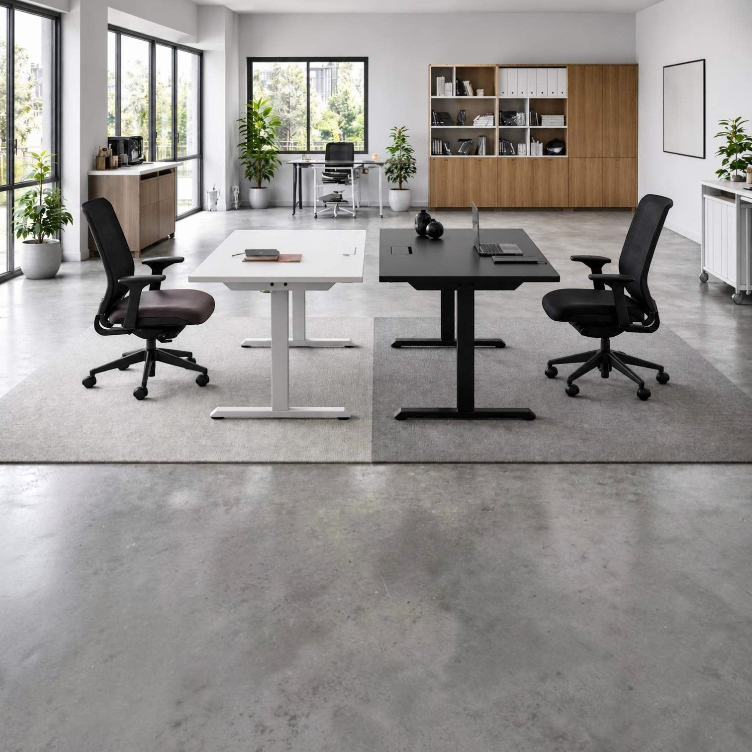 Addo Shop Up Down sit-stand desks in white and black with ergonomic chairs in a modern minimalist office workspace.
