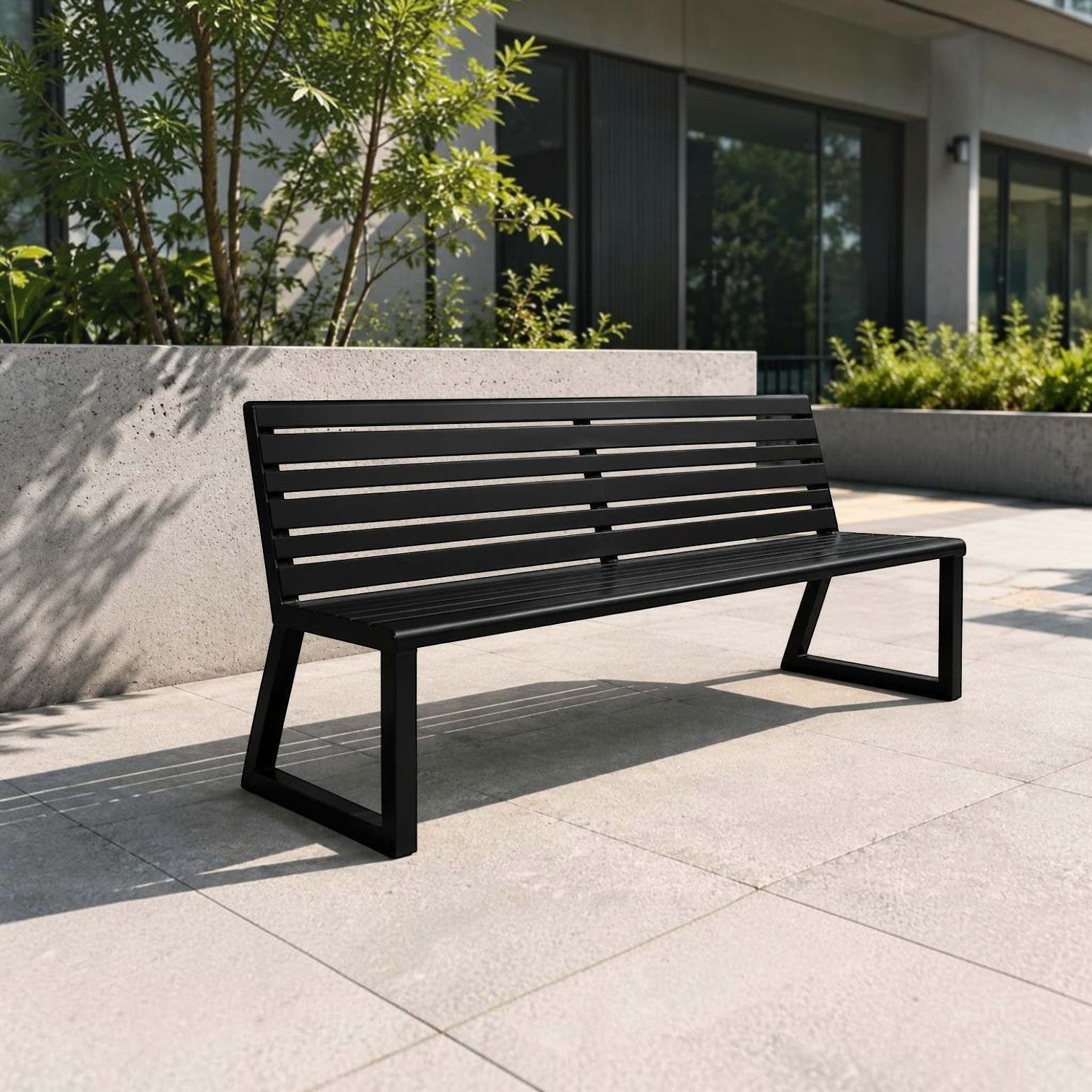 Addo Shop Ventiquattrore.h24 black metal outdoor bench with a slatted backrest on a modern patio.