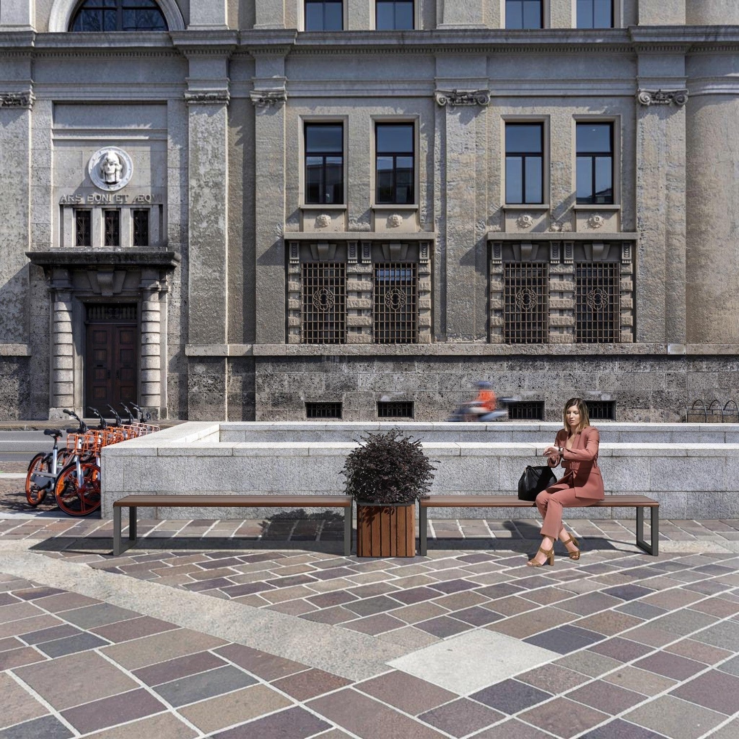 Woman in a pink suit sitting on an Addo Shop Ventiquattrore.h24 flat wooden bench in a modern urban plaza.