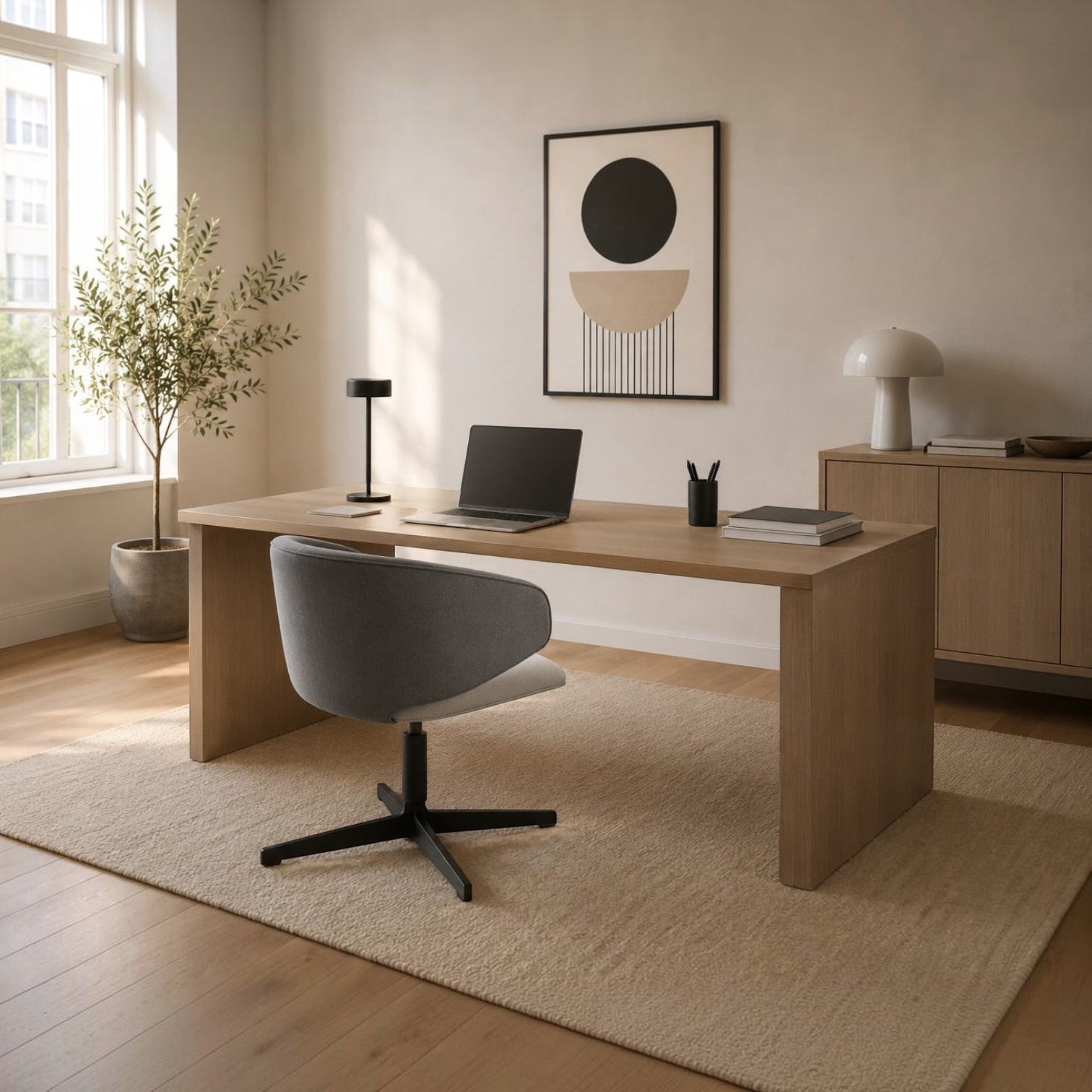 Addo Shop Wing Low lounge chair with grey upholstered seat and black metal swivel base in a modern home office.