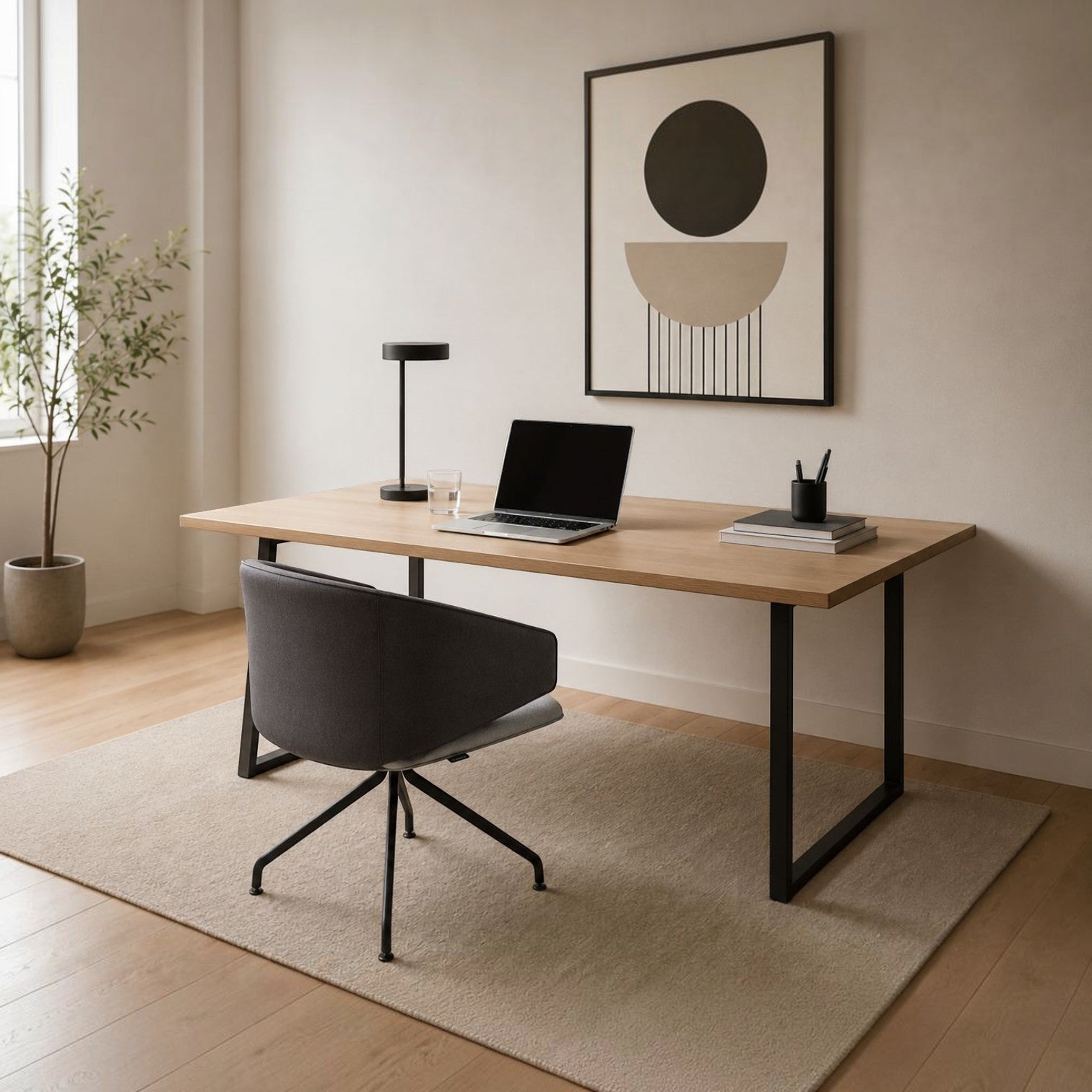 Addo Shop Wing Low lounge chair with dark grey upholstery and black metal base at a modern wooden desk.