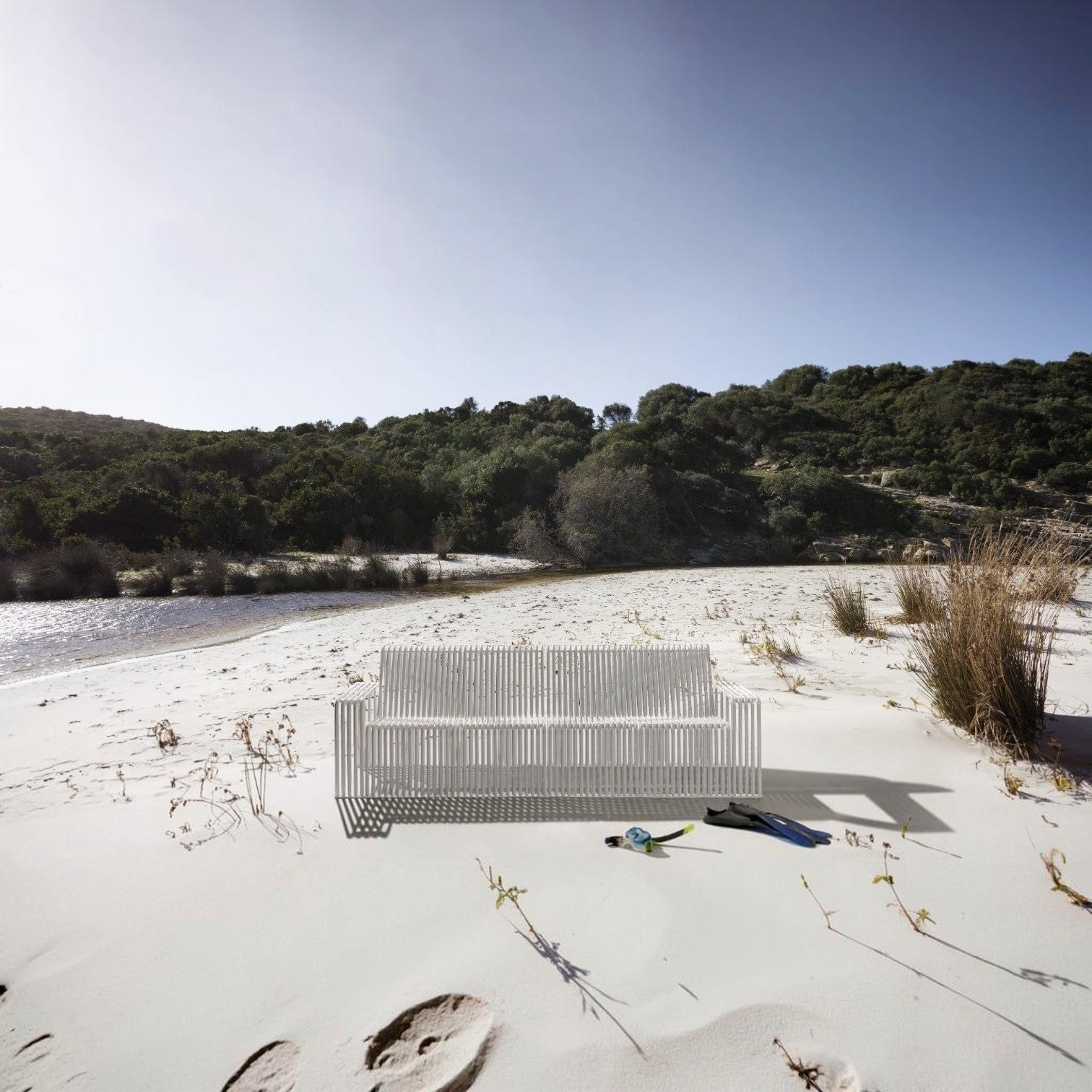 Addo Shop Zeroquindici .015 white slatted 3-seater outdoor sofa on a sandy beach with snorkeling gear nearby.