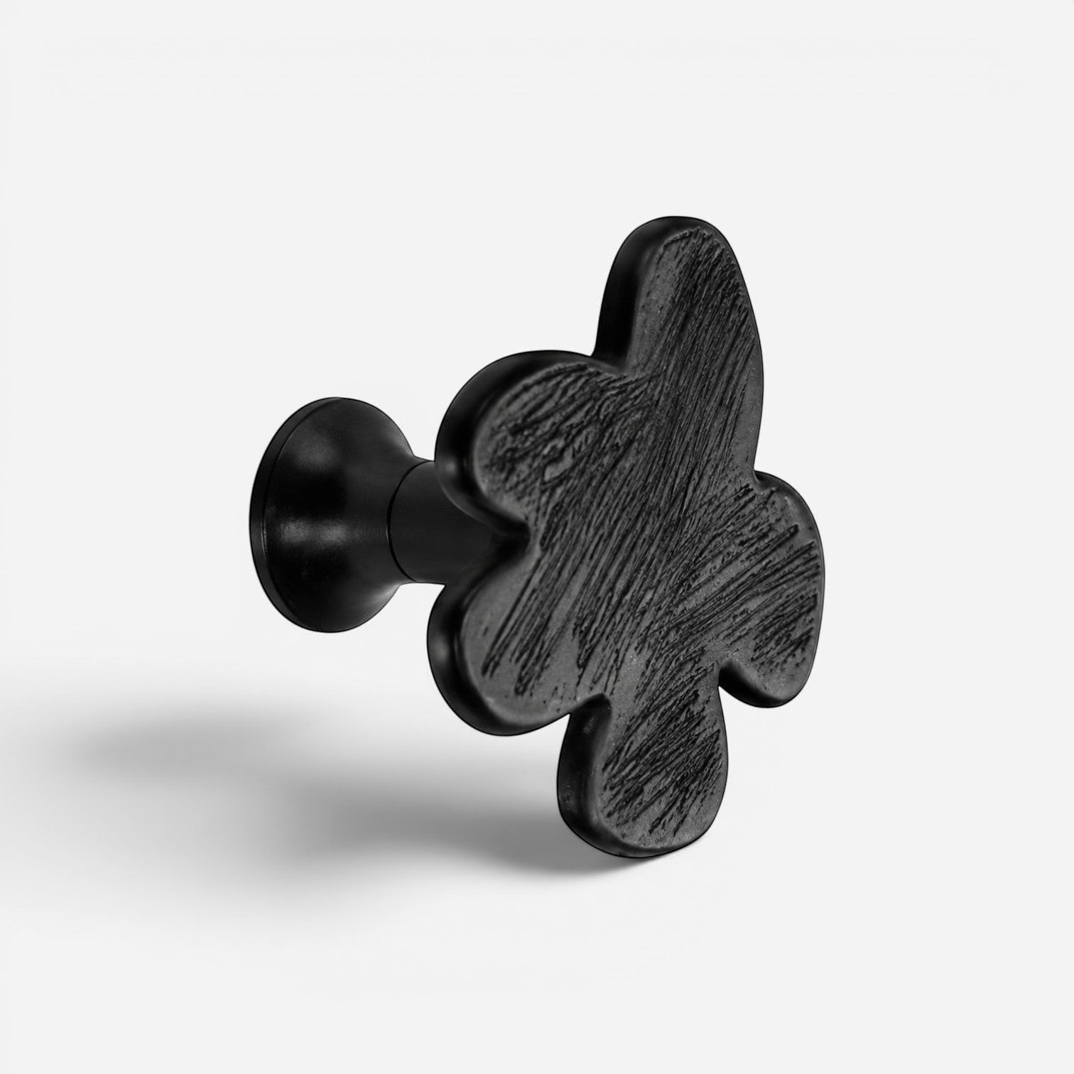 Addo Shop Beta Wall Hook, black, clover-shaped with textured surface, for coats and accessories.