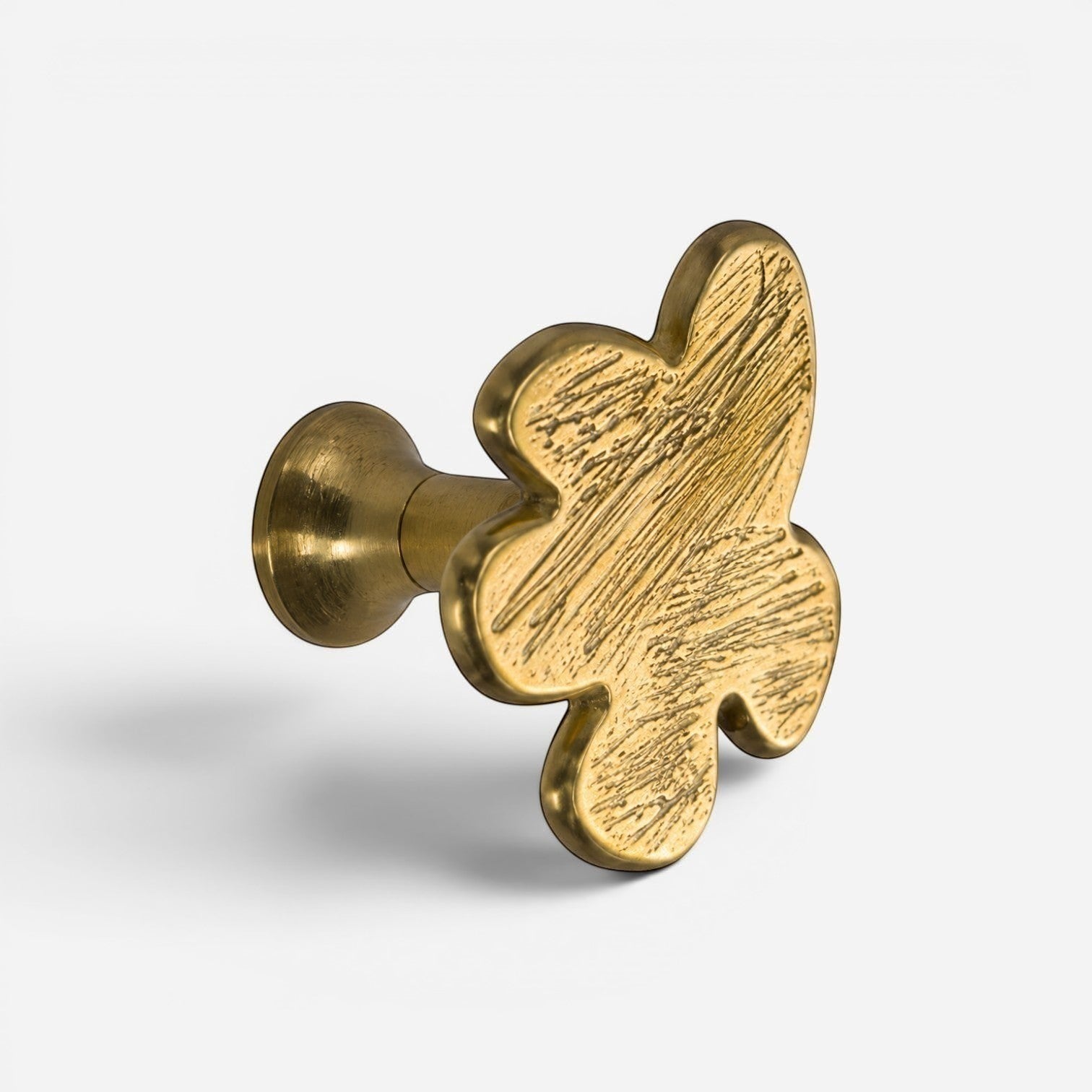Addo Shop Beta Wall Hook, brass, butterfly shape with textured surface.