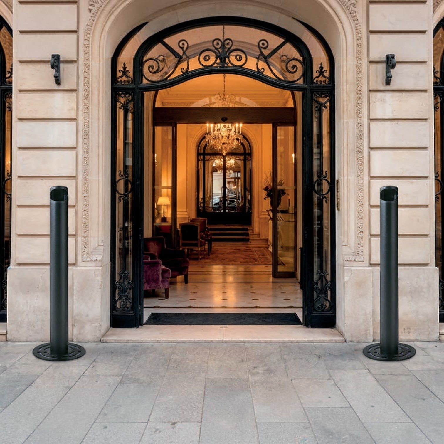 Addo Shop black outdoor ashtray with a sleek cylindrical design and a circular base, placed outside an ornate building entrance.