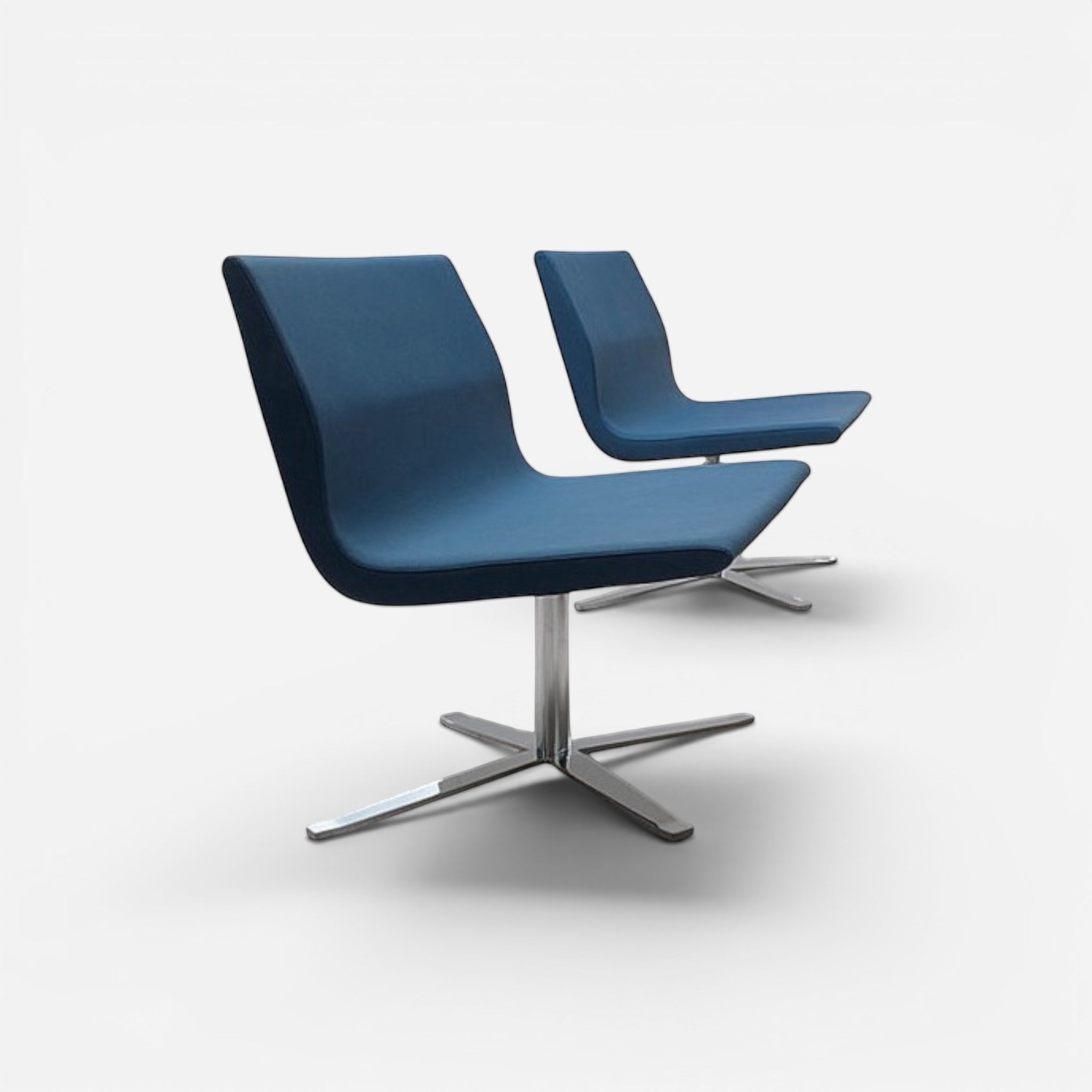 Addo Shop Godot lounge seating chair in blue fabric with a swivel metal base in a modern office setting.