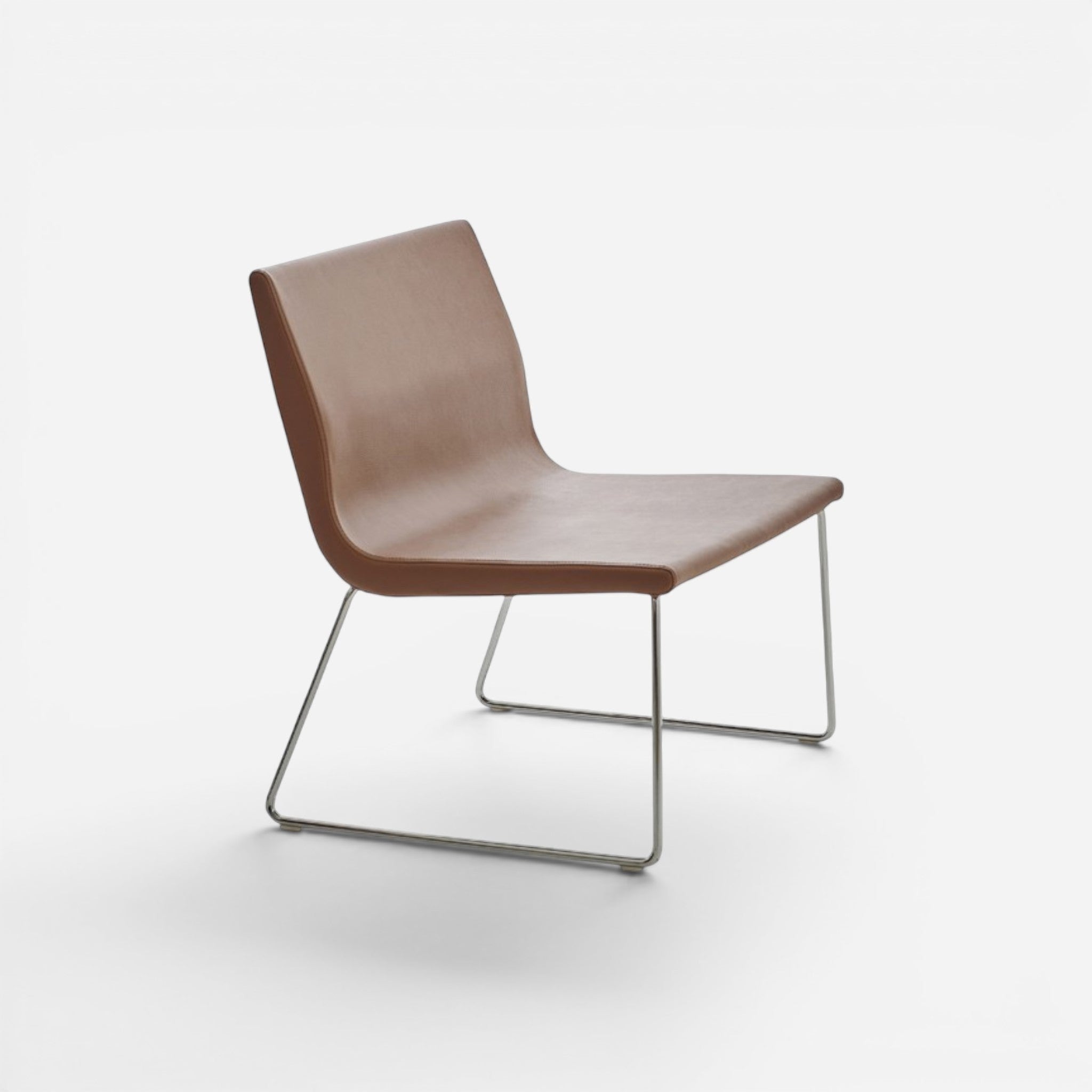 Addo Shop Godot lounge chair in brown faux leather with chrome metal legs and swivel mechanism.