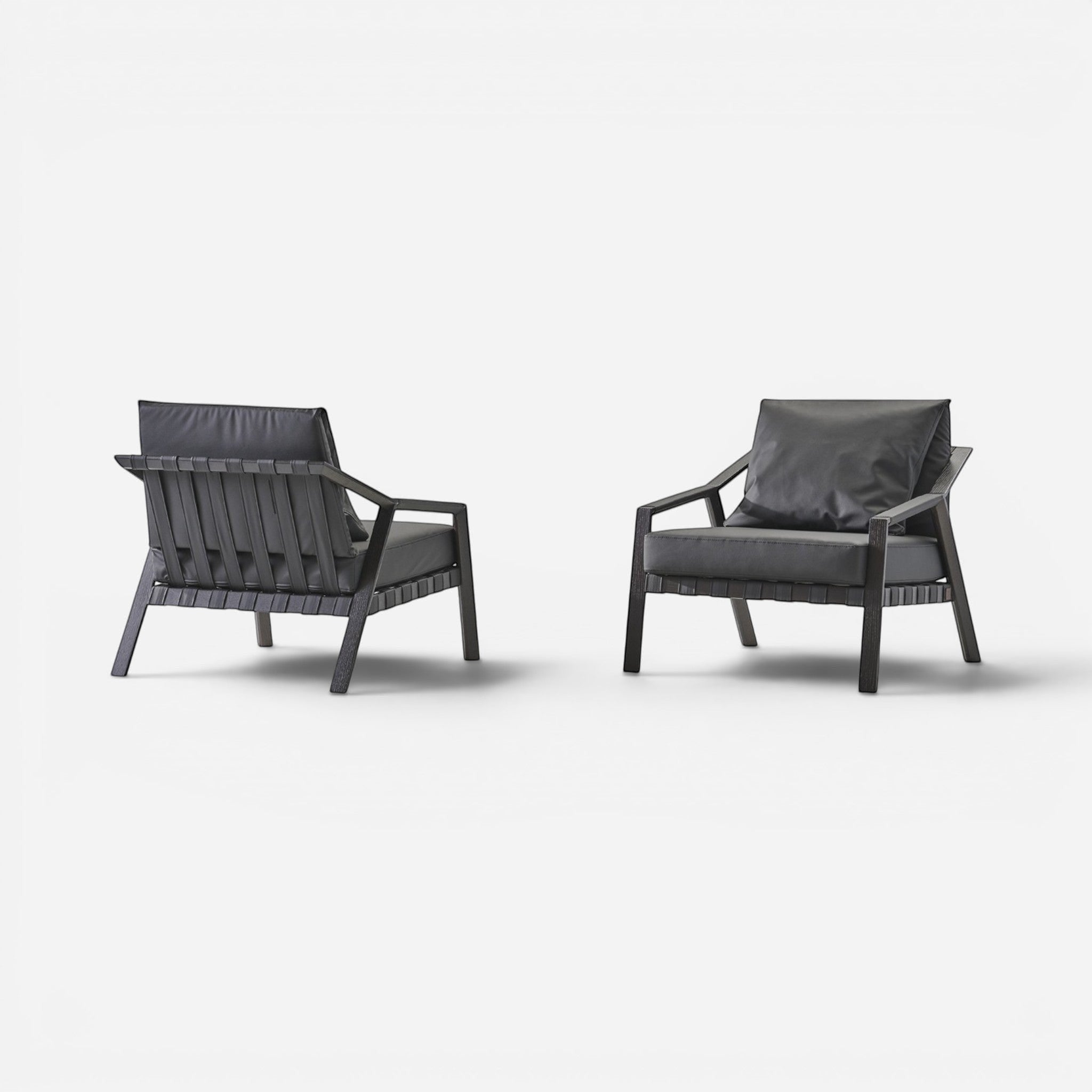 Addo Shop Lares lounge armchair with dark oak frame and black faux leather upholstery. Features woven back detail.